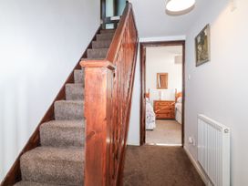 A staircase leading to bedrooms in a hallway at The Hayloft in Common Moor near Liskeard