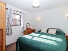 A bedroom with a bed and a dresser at The Hayloft in Common Moor near Liskeard