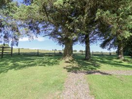 A view of trees and a field from a garden at The Hayloft in Common Moor near Liskeard