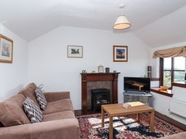 A living room with a sofa and television at The Dairy Common Moor near Liskeard