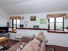 A snug with a sofa and TV at The Dairy Common Moor near Liskeard