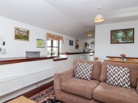 A living room with a sofa and radiator at The Dairy in Common Moor near Liskeard