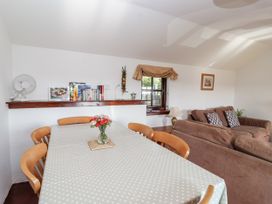 A dining room with a table and chairs at The Dairy in Common Moor near Liskeard