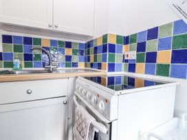 A kitchen with a sink and stove at The Dairy in Common Moor near Liskeard
