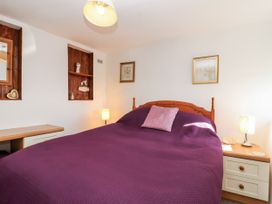 A bedroom with a bed and bedside lamps at The Dairy Common Moor near Liskeard