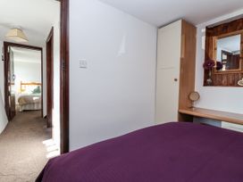 A bedroom with a door leading to another room at The Dairy in Common Moor near Liskeard