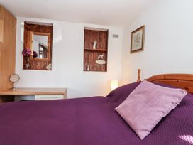 A bedroom with a bed and desk at The Dairy Common Moor near Liskeard