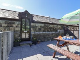 An outdoor seating area with a table and umbrella at The Byre Common Moor near Liskeard