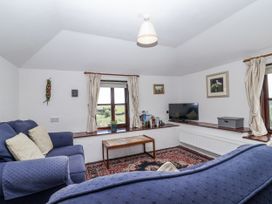 A living room with a television and sofas at The Byre in Common Moor near Liskeard