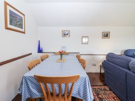 A dining room with a table and chairs at The Byre in Common Moor near Liskeard