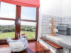 A kitchen with window view of the landscape at The Byre in Common Moor near Liskeard