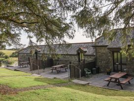 An outdoor seating area with tables and benches at The Byre Common Moor near Liskeard