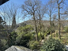 A view of trees and a church spire at Rothay Cottage Ambleside