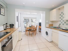 A kitchen with a dining table and chairs at Rothay Cottage in Ambleside