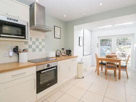 A kitchen with appliances and dining area at Rothay Cottage Ambleside