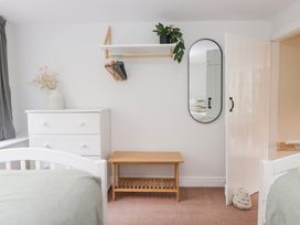 A bedroom with a bed and a chest of drawers at Rothay Cottage in Ambleside