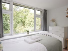 A bedroom with a bed and window view at Rothay Cottage in Ambleside