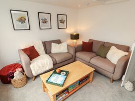 A living room with sofas and a coffee table at Rothay Cottage in Ambleside