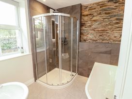 A bathroom with a shower and bathtub at Rothay Cottage Ambleside