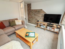A living room with a sofa and television at Rothay Cottage in Ambleside
