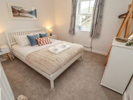 A bedroom with a bed and nightstand at Rothay Cottage in Ambleside