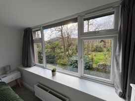 A living room with a window view of the garden at Rothay Cottage Ambleside