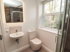 A bathroom with a toilet, sink, and shower at Rothay Cottage, Ambleside