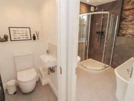 A bathroom with a shower, toilet, and bathtub at Rothay Cottage in Ambleside