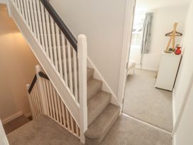 A hallway with stairs leading to an upper floor at Rothay Cottage Ambleside