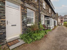 An entrance with a door and sign for Rothay Cottage in Ambleside