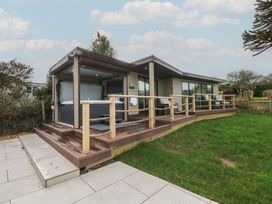 An outdoor area with a hot tub and decking at The Bay in Benllech