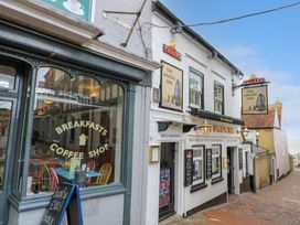 A street view of a building with signs for a breakfast coffee shop and the Union Inn pub at Greenwood in Cowes