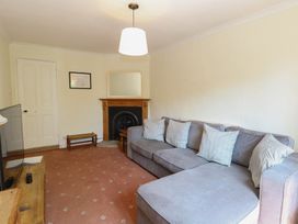 A living room with a sofa and television at Iona Cottage Southwold
