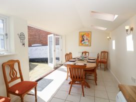 A dining room with a table and chairs at Iona Cottage Southwold