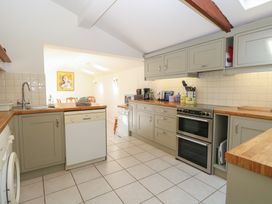A kitchen with cabinets and appliances at Iona Cottage in Southwold