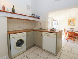 A kitchen with washing machine and dishwasher at Iona Cottage Southwold