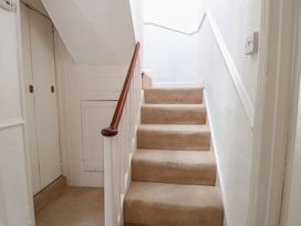 A staircase with a handrail at Iona Cottage Southwold