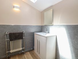 A bathroom with a sink and towel radiator at Iona Cottage Southwold