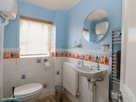 A bathroom with a toilet and sink at Iona Cottage Southwold