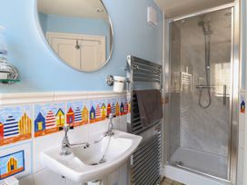A bathroom with sink and shower at Iona Cottage in Southwold