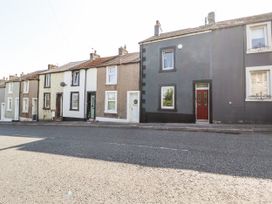 A row of houses with different colored facades at 10 Keekle Terrace in Cleator Moor