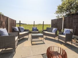 An outdoor seating area with chairs and a table at 10 Keekle Terrace in Cleator Moor