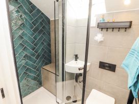 A shower area with a toilet and sink at 10 Keekle Terrace in Cleator Moor