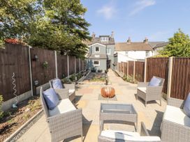 A garden with seating area and pathway at 10 Keekle Terrace in Cleator Moor