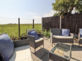 A garden with patio furniture at 10 Keekle Terrace in Cleator Moor