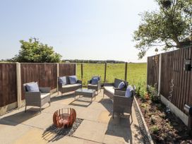 An outdoor seating area with chairs and a table at 10 Keekle Terrace in Cleator Moor