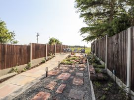A garden with a pathway and seating at 10 Keekle Terrace in Cleator Moor