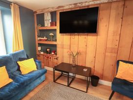 A living room with a sofa and tv at 10 Keekle Terrace in Keekle near Cleator Moor