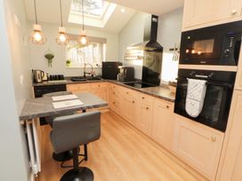 A kitchen with modern appliances and a table at 10 Keekle Terrace in Keekle near Cleator Moor