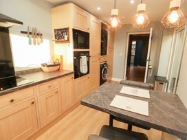 A kitchen with cabinets and appliances at 10 Keekle Terrace in Keekle near Cleator Moor